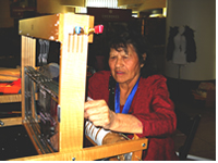 UKB tribal elder and Tradition Keeper Dorothy Ice demonstrates textile weaving at the National Museum of the American Indian.